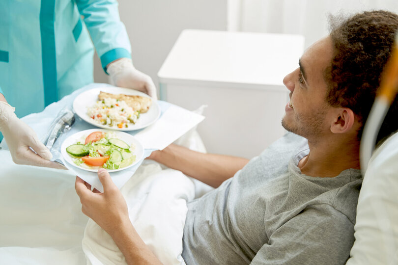 A patient receiving a meal