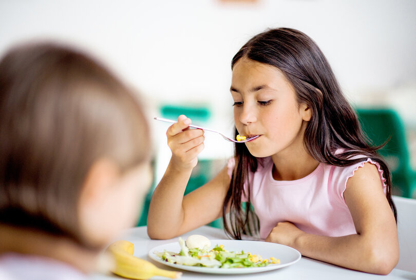 School girl eats lunch
